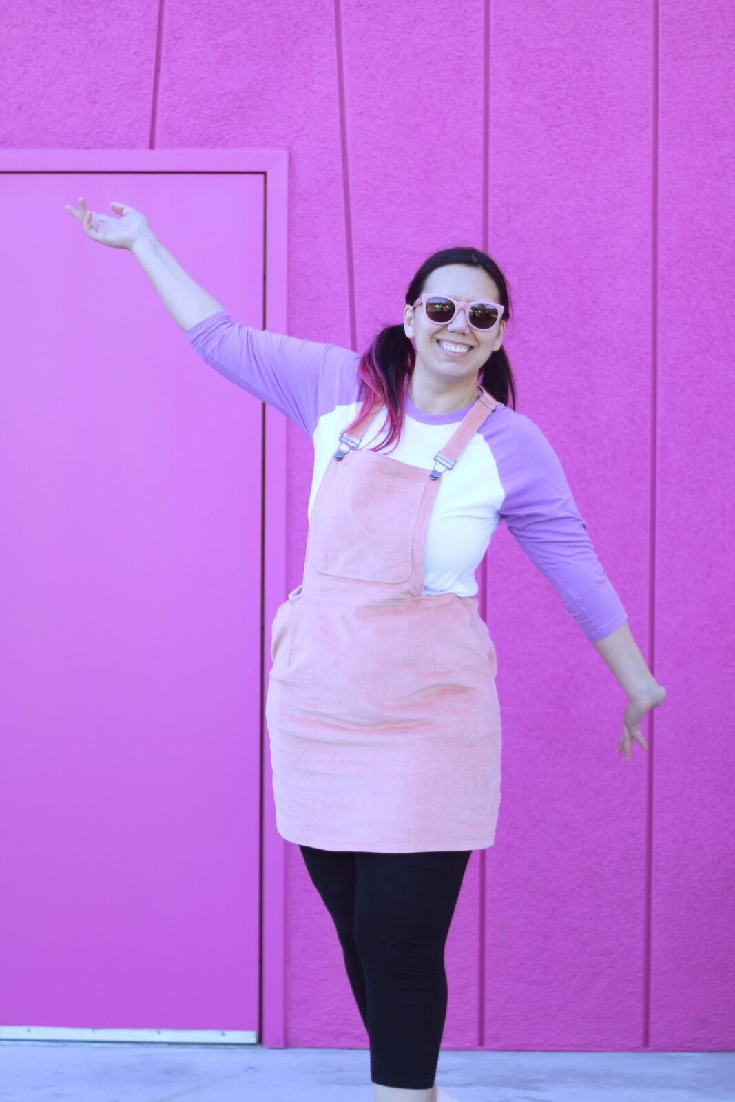 Care Bear inspired comfortable travel outfit with a pink pinafore and a lilac raglan shirt